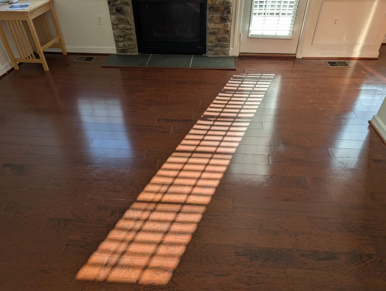 Same hardwood floor after cleaning, deep glossy shine restored